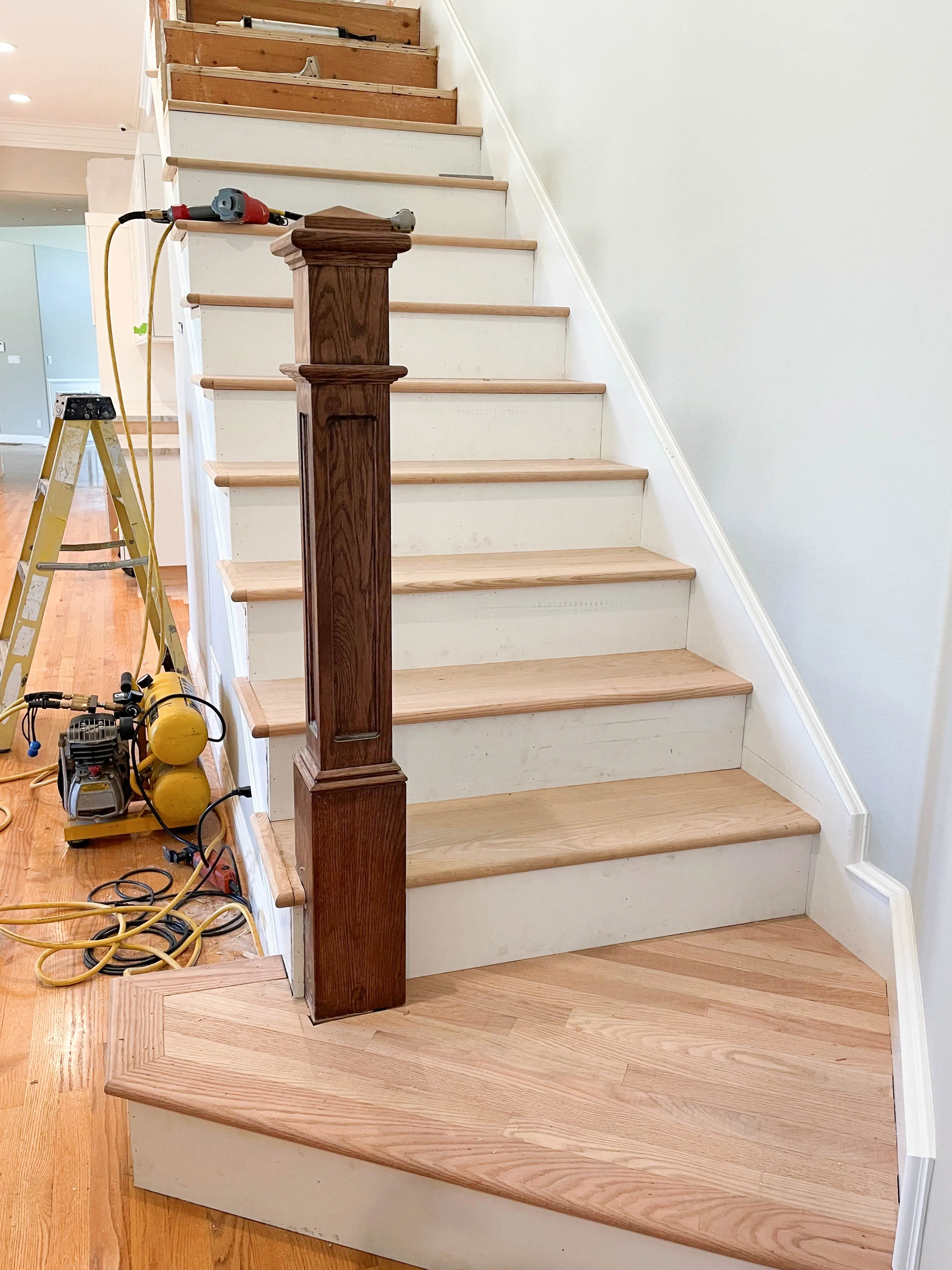 Picture of Alva Flooring installed solid unfinished red oak with paint-grade pine risers on this staircase. - Alva Flooring Inc.