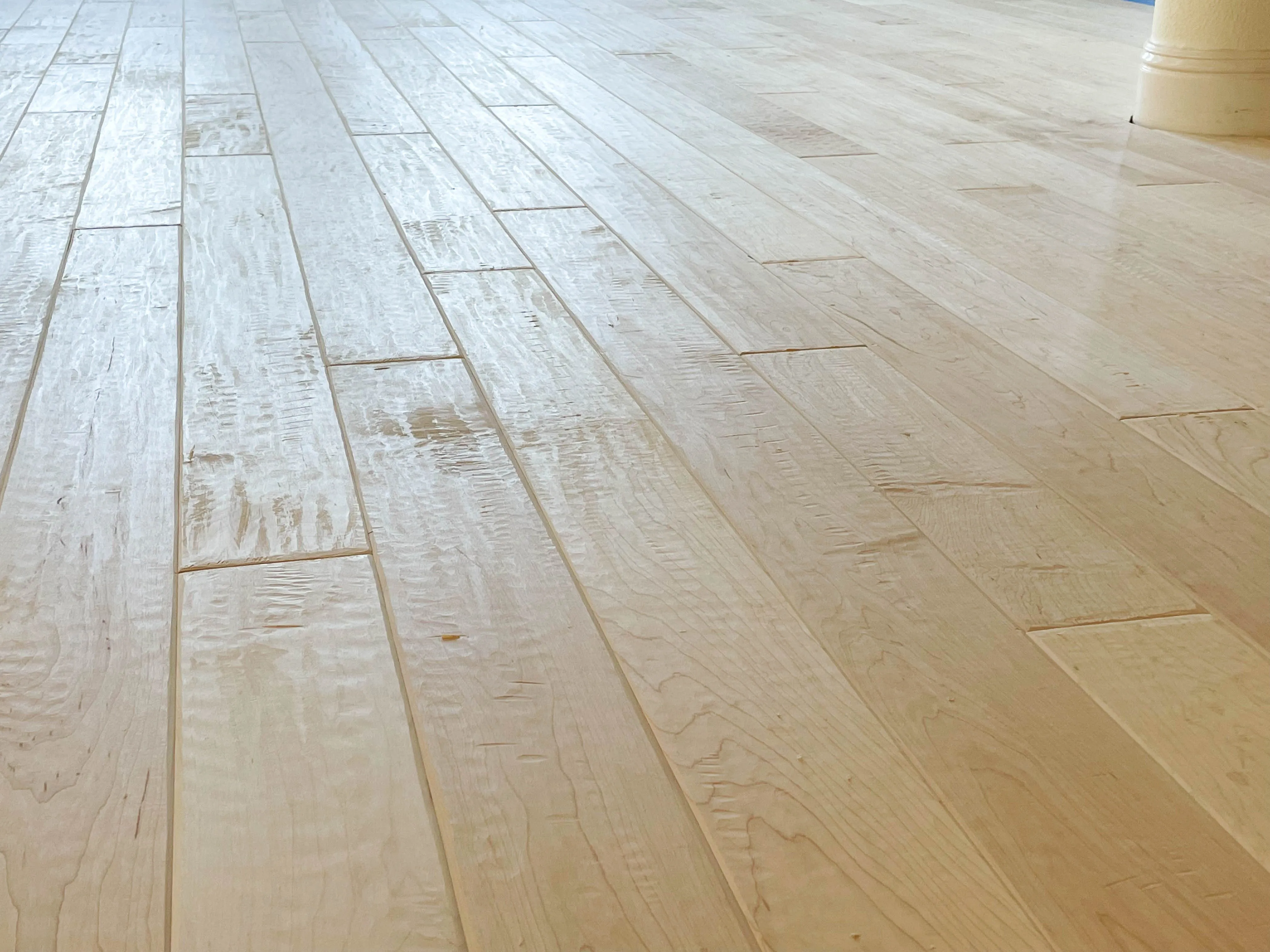 Picture of An engineered unfinished maple floor after a custom hand scraping and before staining - Alva Flooring Inc.