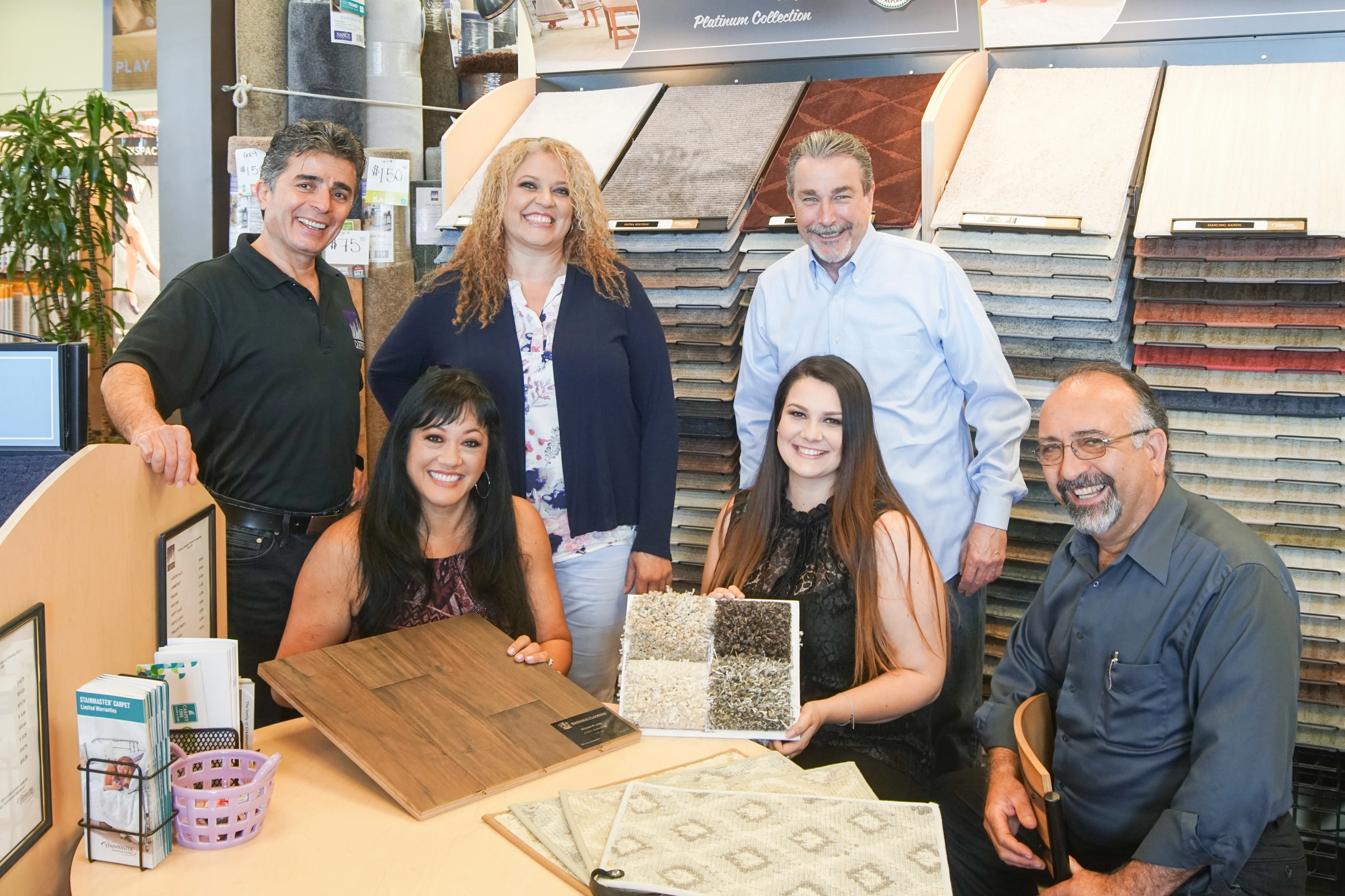 Picture of City Carpets' staff members educate customers about their flooring choices. - City Carpets