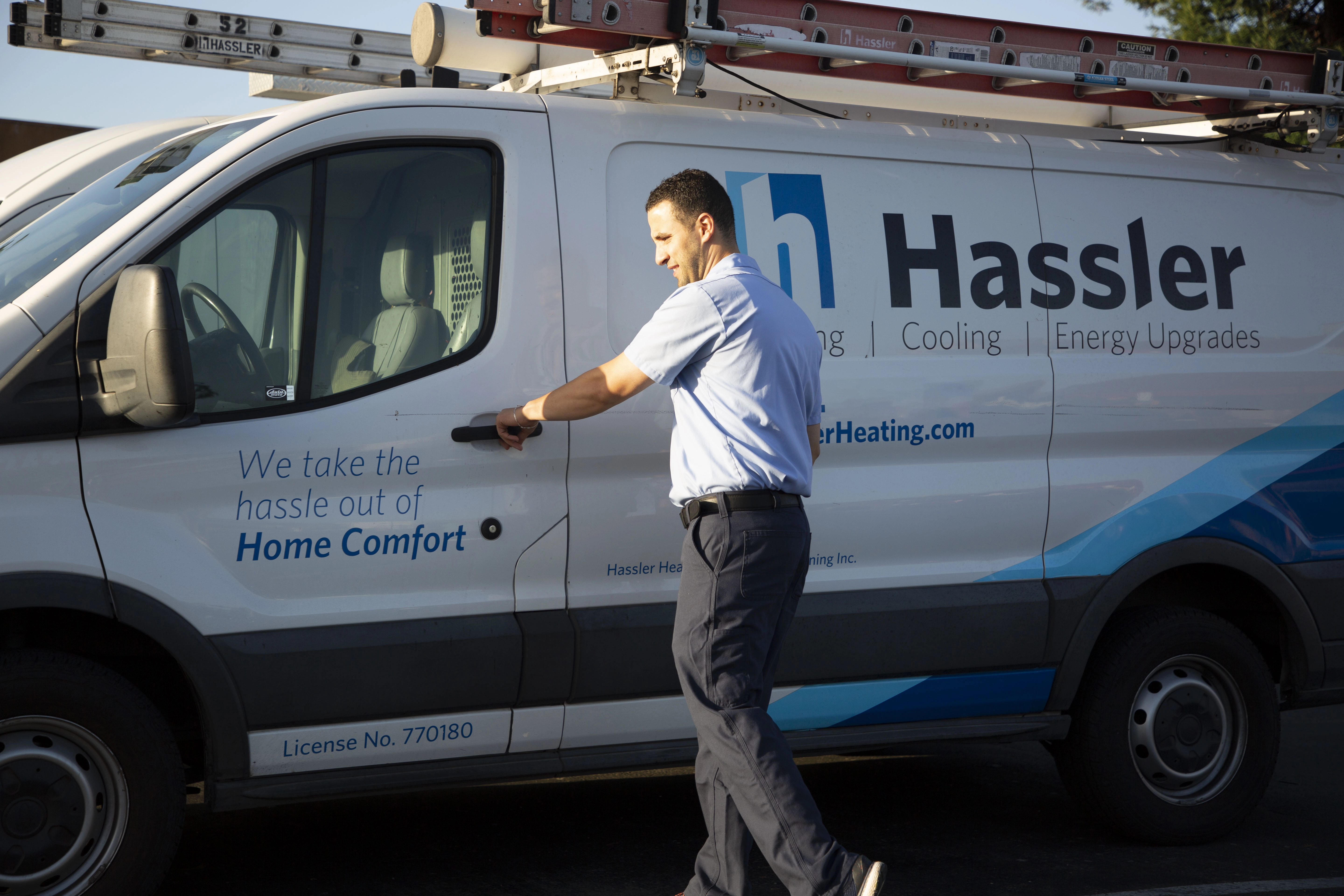 Picture of A Hassler technician heads to a jobsite. - Hassler Heating & Air Conditioning, LLC