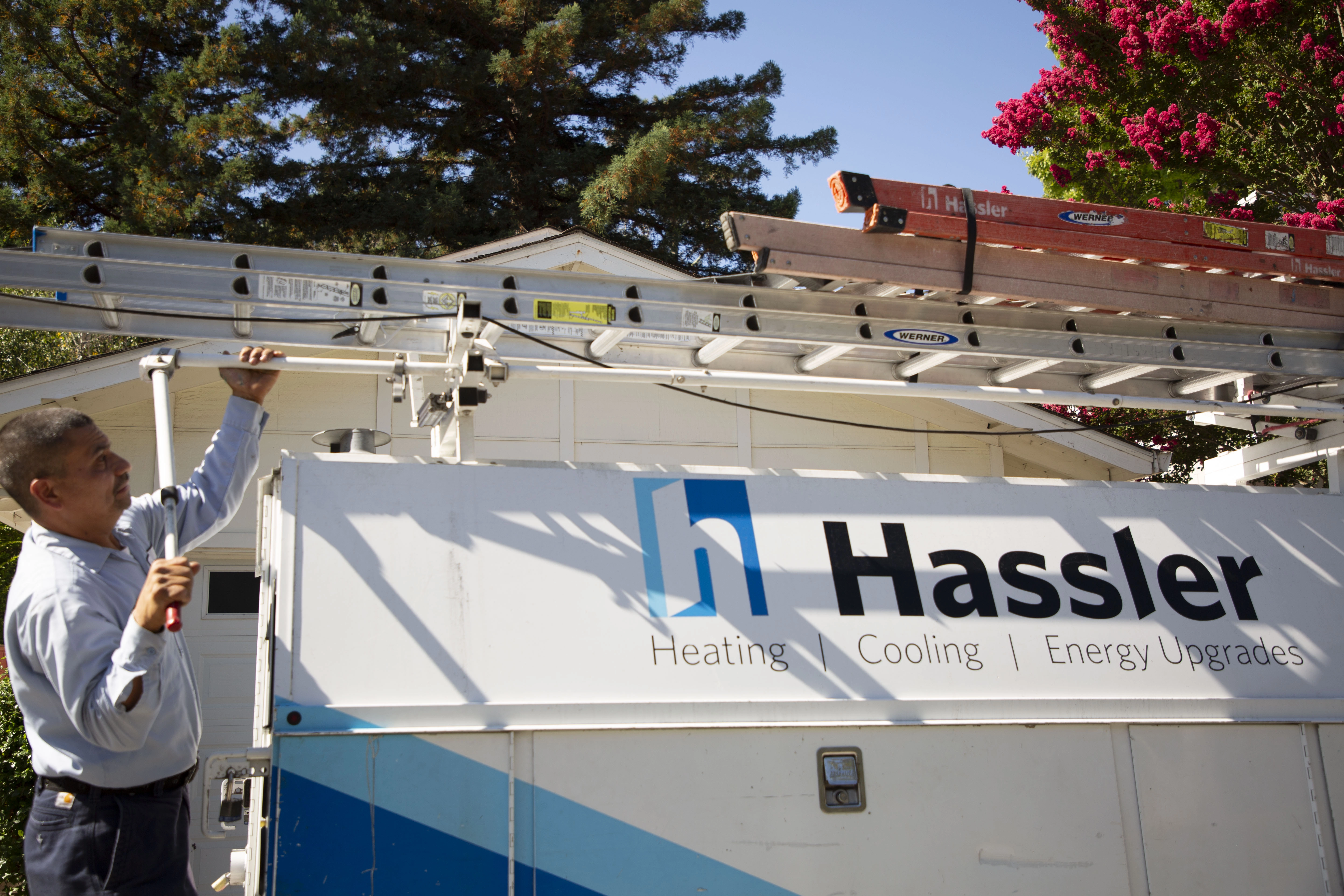 Picture of A Hassler technician installs a new AC system. - Hassler Heating & Air Conditioning, LLC