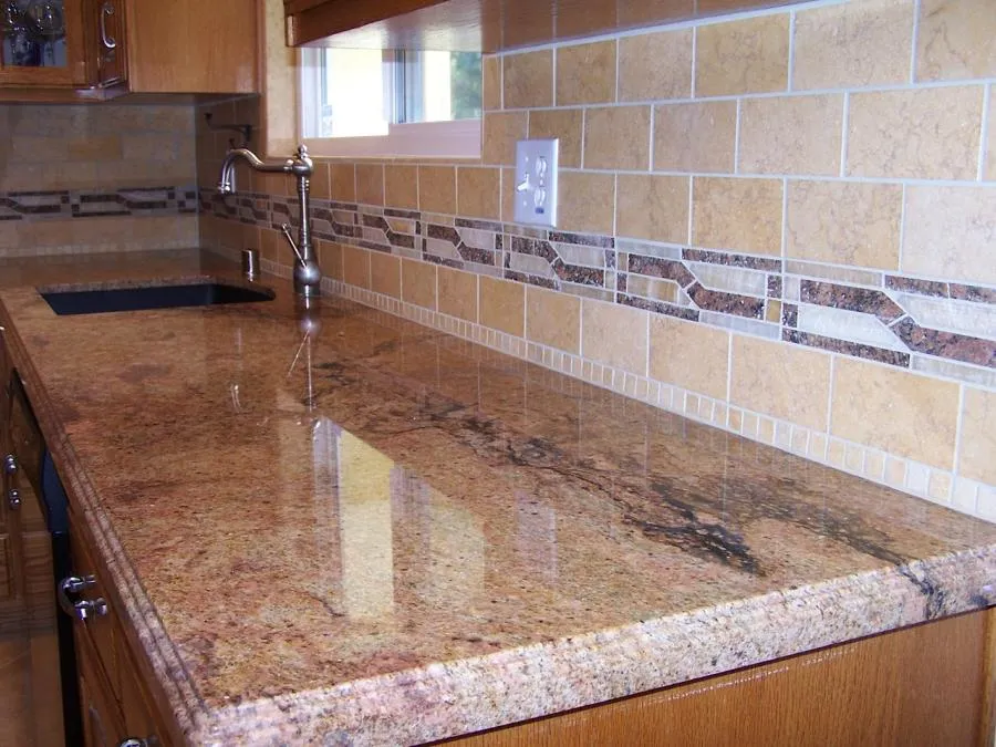 Picture of Bordeaux granite with travertine and slate backsplash. - Labourdette Construction