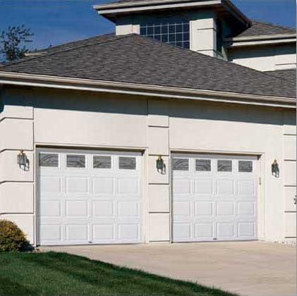 Picture of Steel raised panel garage doors with decorative glass top sections in Concord - Madden Door & Sons, Inc.