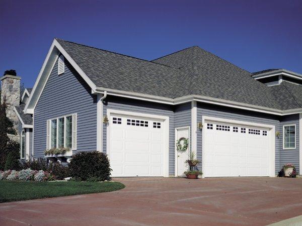 Picture of Raynor mixed panel steel garage doors with grid windows in Dublin - Madden Door & Sons, Inc.