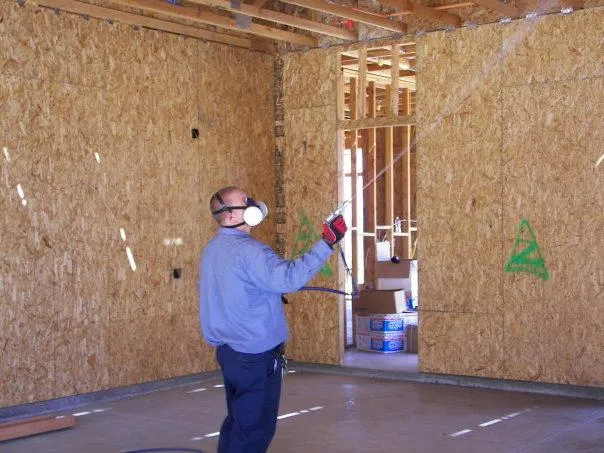 Picture of A Pacific Coast Termite technician sprays for termites. - Pacific Coast Termite