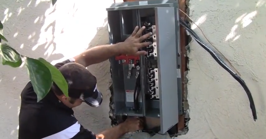 Picture of A California Power and Light technician replaces a customer's electrical panel. - California Power and Light