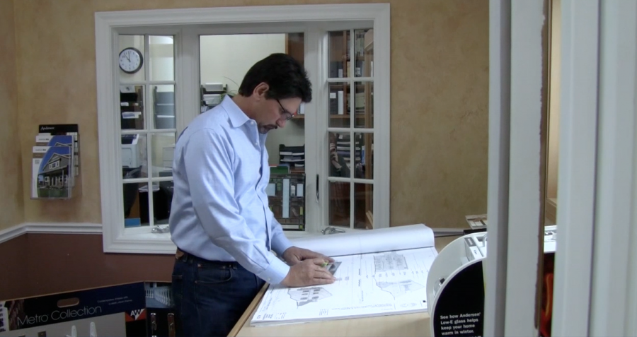 Picture of Owner John Scalmanini looks over drafts for a window installation project. - Anderson Window & Door Installation