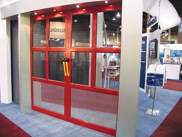 Picture of A unique firehouse aluminum/glass garage door in powder coated red - Madden Door & Sons, Inc.