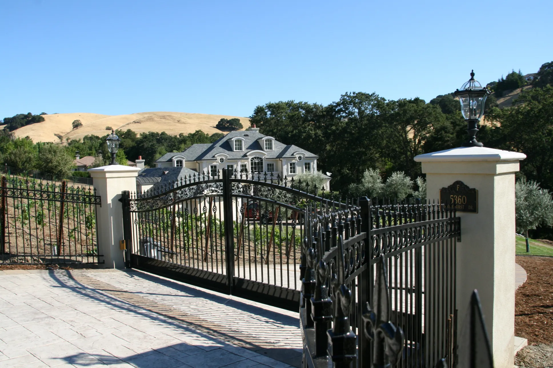 Picture of A & J Fencing installed this custom fabricated ornamental iron fence and automatic gate. - A & J Fencing