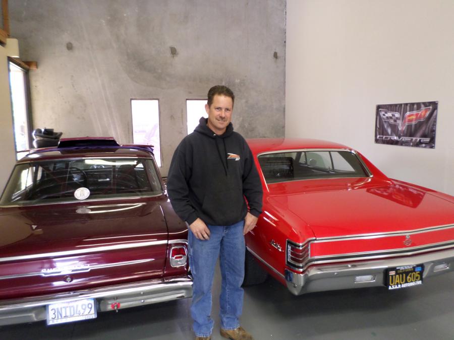 Picture of Owner Ron McLeod stands next to two recently repaired classic cars. - ASAP Automotive, Inc.