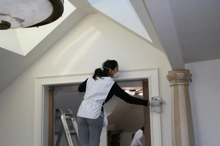 Picture of A SonoMarin Cleaning Services employee cleans a client's baseboards. - SonoMarin Cleaning Services, Inc.