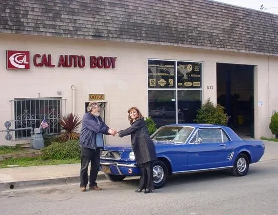 Picture of Owner Nana Sarkisian (R) stands with a customer outside Cal Auto Body's Colma shop. - Cal Auto Body