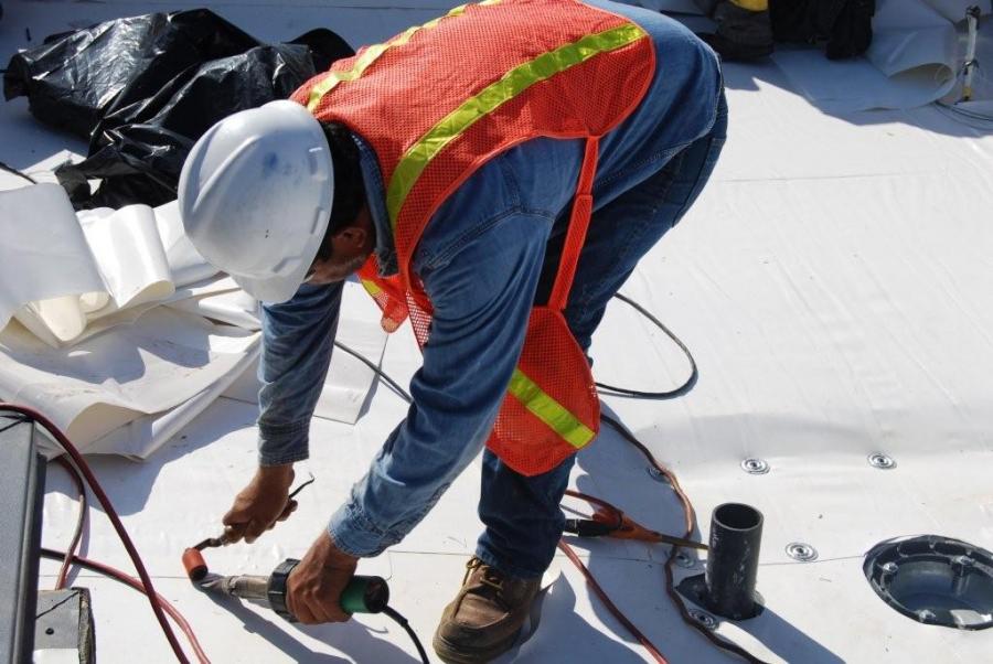 Picture of An All Seasons Roofing & Waterproofing technician works on a client’s roofing system. - All Seasons Roofing & Waterproofing, Inc.