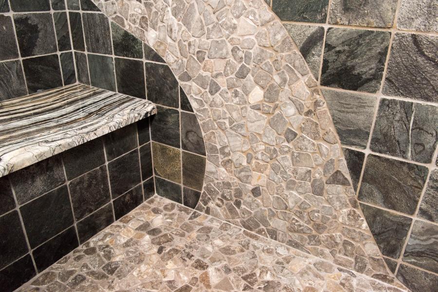 Picture of This shower features slate walls, a marble slab seat and a mosaic design that gives the appearance of a river rock bed. - Derrick Tracey Custom Tile & Marble