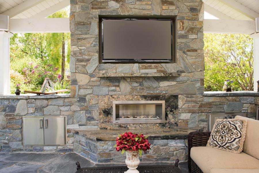 Picture of This outdoor entertainment center in San Ramon features rock on the walls of a marble slab fireplace. - Derrick Tracey Custom Tile & Marble