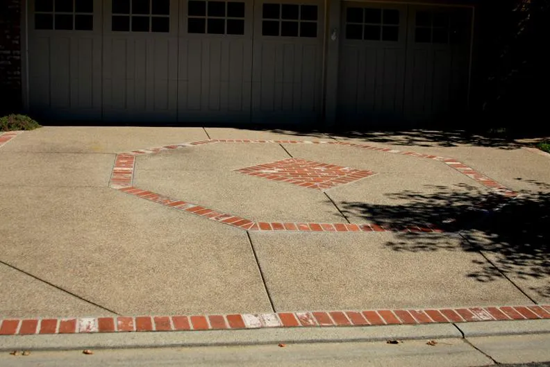 Picture of An exposed aggregate driveway with brick inlay in Walnut Creek - Dana Lund Landscaping, LLC