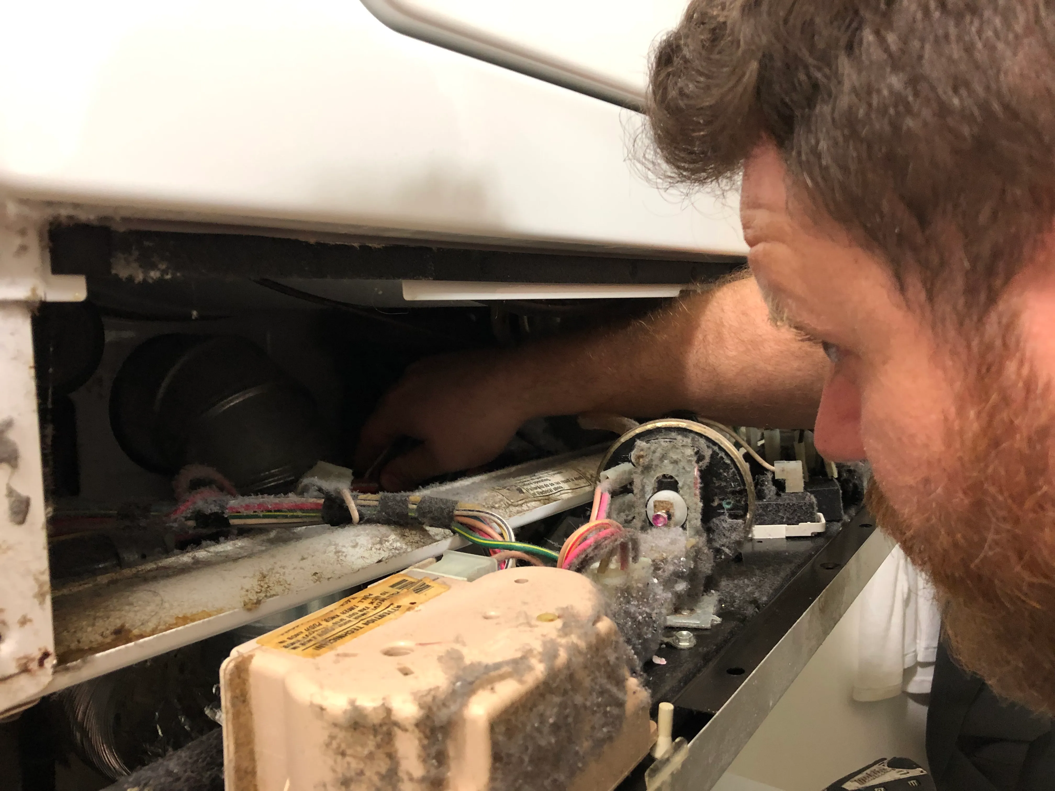 Picture of A FixEm Appliance Repair technician diagnoses a stacked combo washer and dryer. - FixEm Appliance Repair