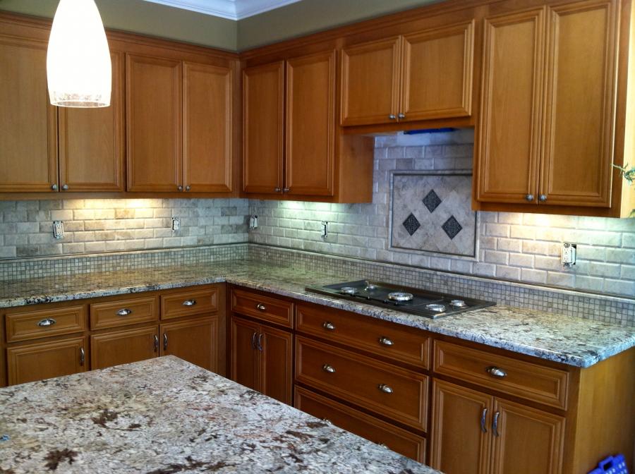 Picture of A recent kitchen project featuring 3×6 tile backsplash with mosaic tile on the bottom and a design behind the cooktop - Derrick Tracey Custom Tile & Marble