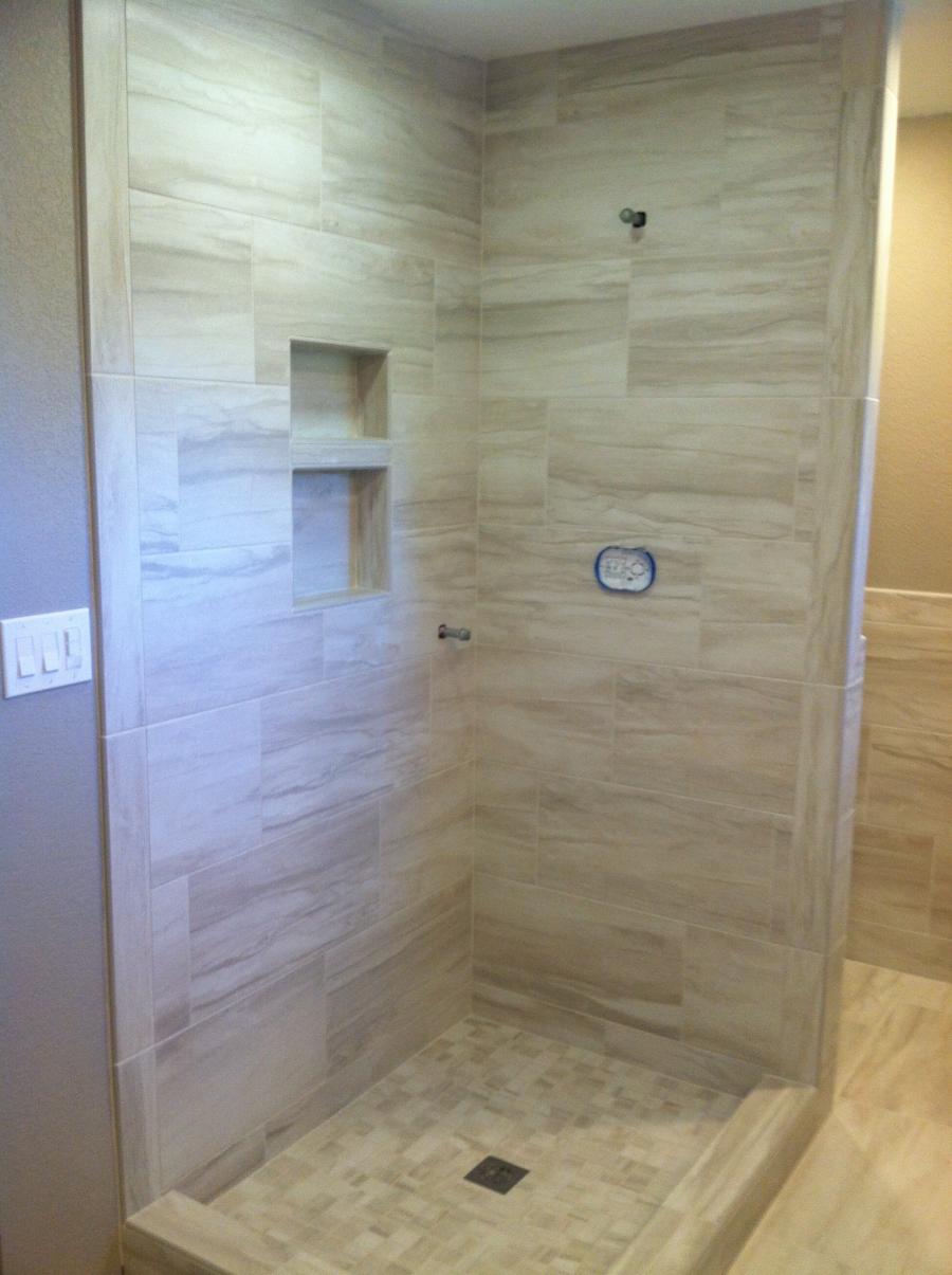 Picture of This shower features 12×24 tile walls and 2×2 tiles on the shower pan. - Derrick Tracey Custom Tile & Marble