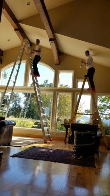 Picture of Two Maine Electric Inc. technicians perform a lighting installation. - Service Champions