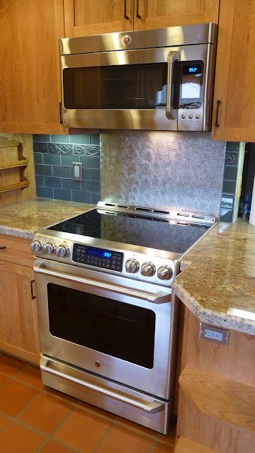 Picture of This kitchen remodeling project features custom stainless steel backsplash and glass tile. - Brian Fitzmaurice General Contractor