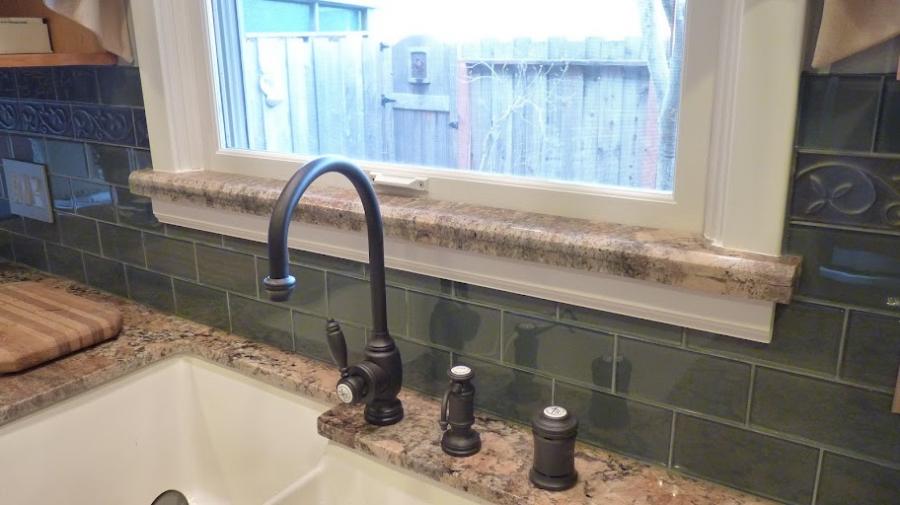 Picture of This kitchen remodeling project features glass tile backsplash and a stone windowsill. - Brian Fitzmaurice General Contractor