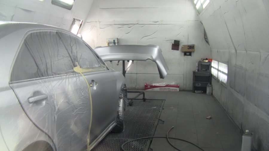 Picture of A customer’s vehicle awaits a paint job in Proline Auto Body Services’ paint booth. - Proline Auto Body Services, Inc.