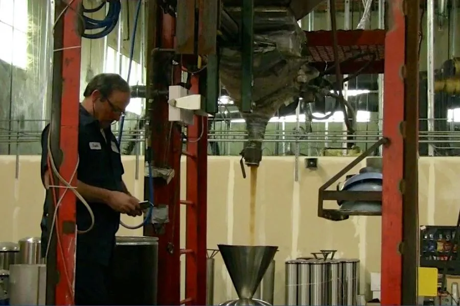 Picture of A Puronics technician fills a water treatment system with filter media which is a key component in treating water to filter down hardness taste odor and chlorine. - Puronics, LLC