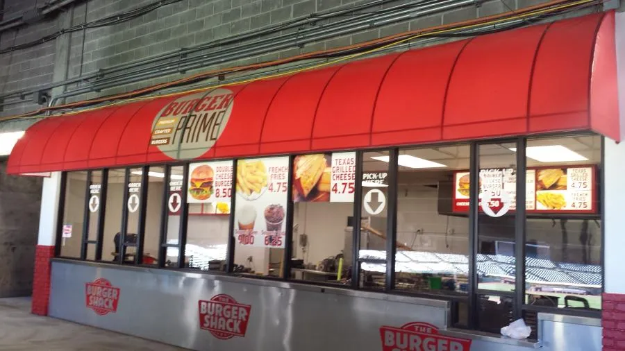 Picture of Acme Sunshades Enterprise installed this quarter barrel awning with a backlight at the Oakland Coliseum. - Acme Sunshades Enterprise Inc.