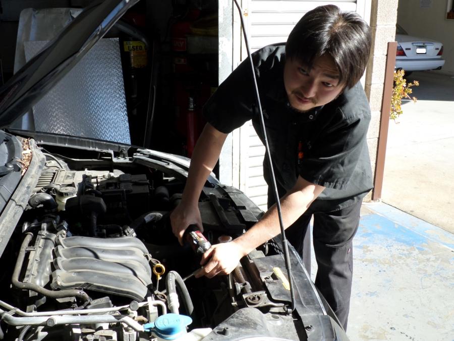 Picture of Sean works on a customer's car. - T & S Auto Repair