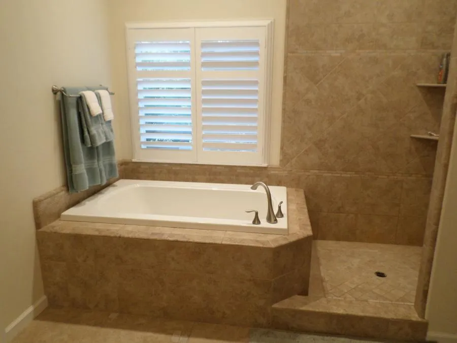 Picture of Thompson Construction placed inexpensive tiles in varied patterns to create an expensive custom look for this deep soak tub. - Thompson Construction, Inc.