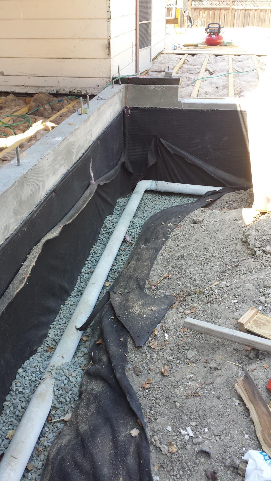 Picture of Willow Creek Construction installed this French drain next to a retaining wall on a clientÛªs property. - Willow Creek Construction