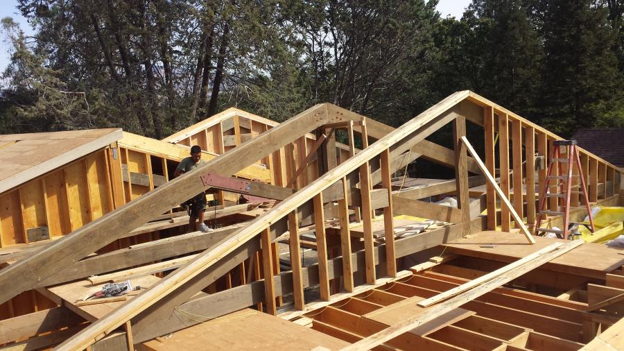 Picture of A Willow Creek Construction technician works on the trusses of a project. - Willow Creek Construction