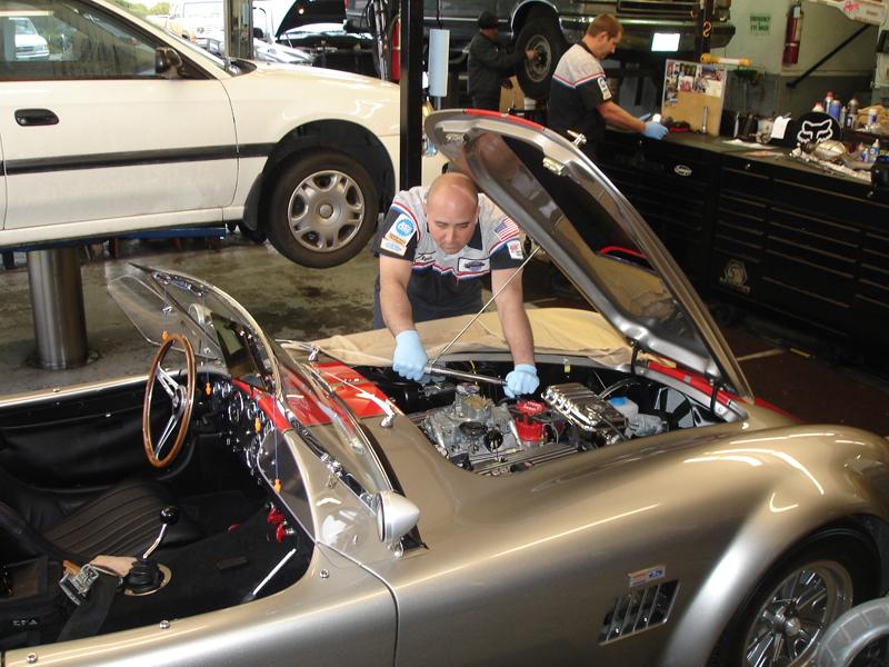 Picture of Manager Ryan Devonshire applies his expertise to a customerÛªs car. - Ernie's Service Center