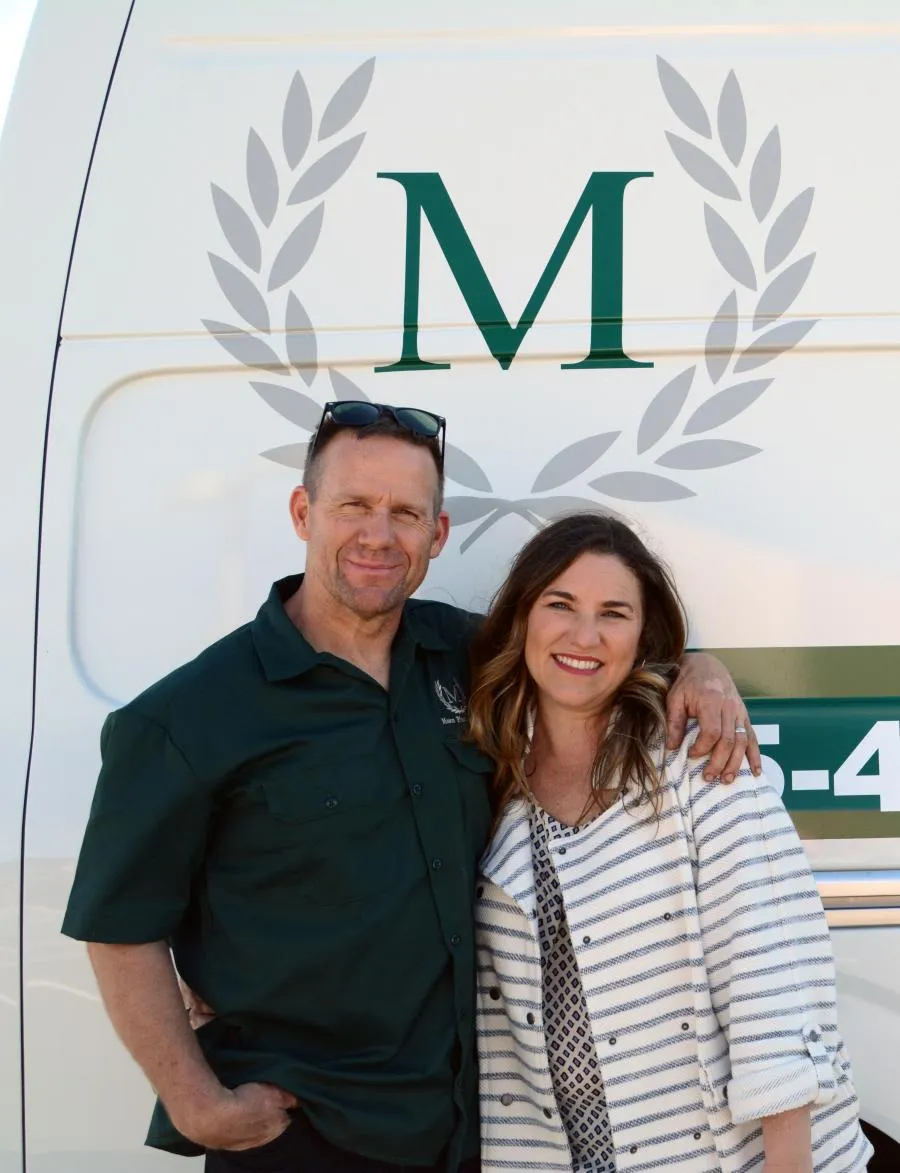 Picture of CEO Cameron Mason stands next to Mason Plumbing's fleet of service vans. - Mason Plumbing, Inc.