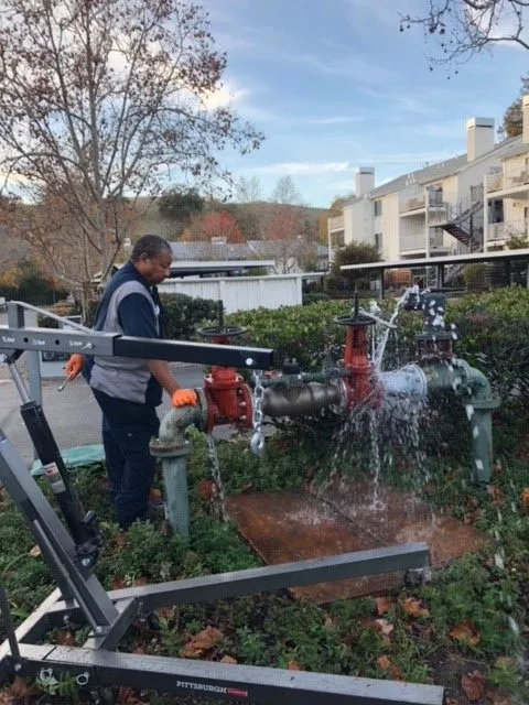 Picture of An Absolute Plumbing and Drain technician repairs a 4-inch backflow device. - Absolute Plumbing and Drain