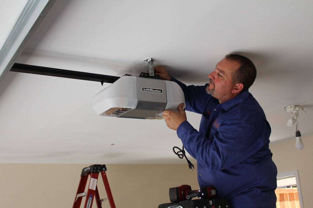 Picture of An Alcal Specialty Contracting technician installs a LiftMaster garage door opener. - Alcal Specialty Contracting, Inc.