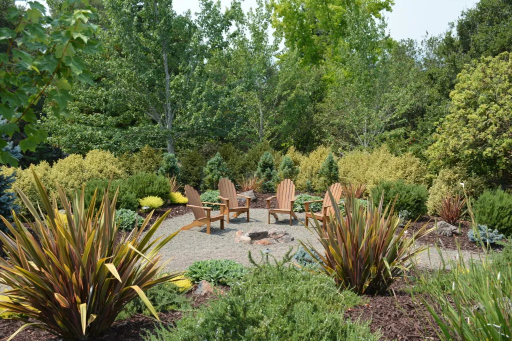 Picture of This rustic Meditteranean-style landscape features a boulder fire pit. - Manzanita Landscape Construction, Inc.