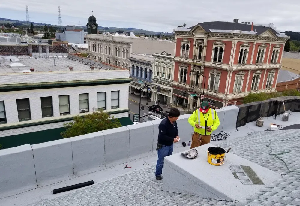 Picture of Two JK Pro Roofing technicians prepare to work on a roofing project. - JK Pro Roofing, Inc.