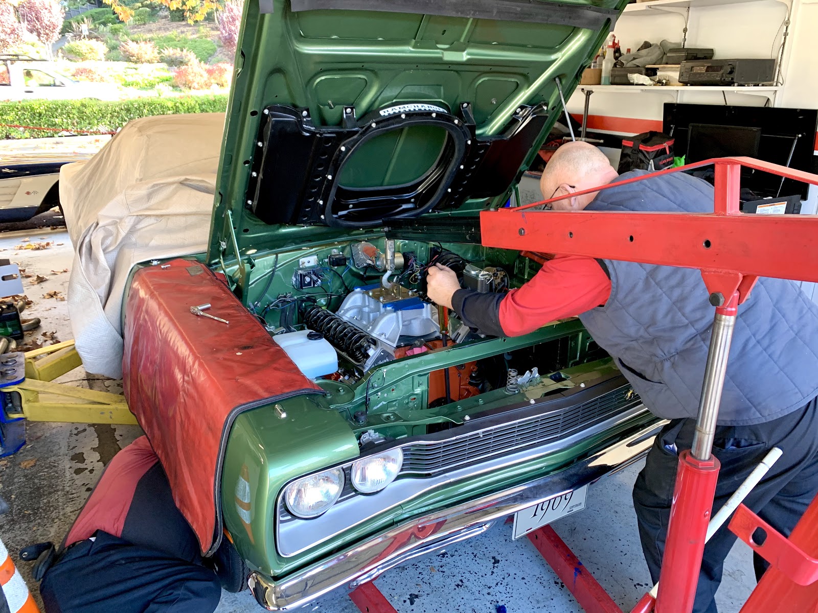 Picture of An Orinda Motors technician works under the hood of a customer’s car. - Orinda Motors, Inc.