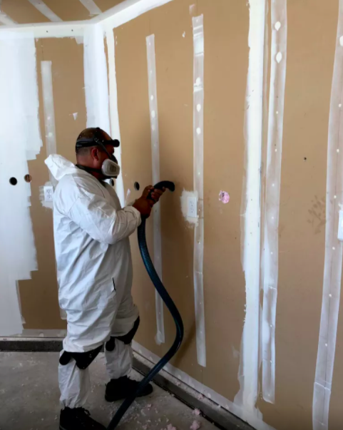 Picture of A Johnson’s Insulation technician dense packs 2×4 walls. - Johnson's Insulation