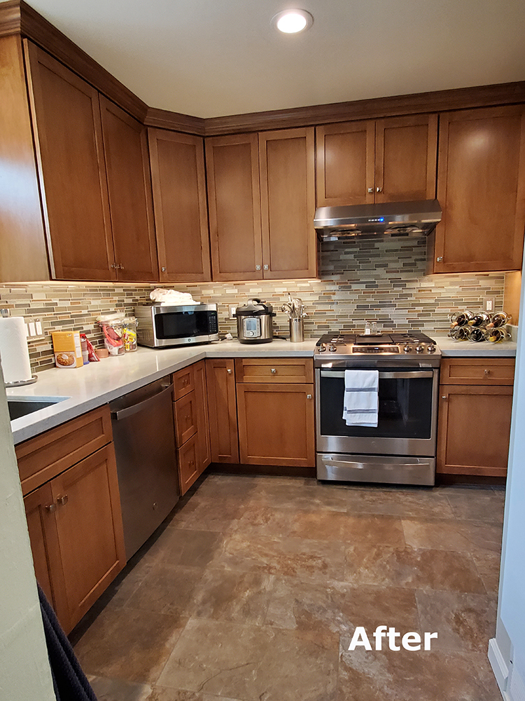 Picture of These Dura Supreme cabinets are accented by a diamond chip quartz countertop from One Quartz. The GE fridge oven and dishwasher match the Miseno stainless steel sink and the Delta faucet. - Cook's Kitchen & Bath, Inc.