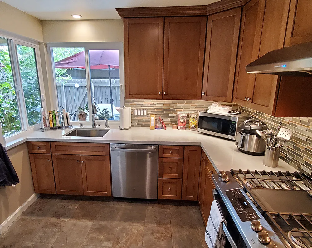 Picture of The floor tile in this kitchen is carefully matched to the striking Crystal Shores Sapphire Lagoon Mosaic tile backsplash which brings the entire kitchen together. - Cook's Kitchen & Bath, Inc.