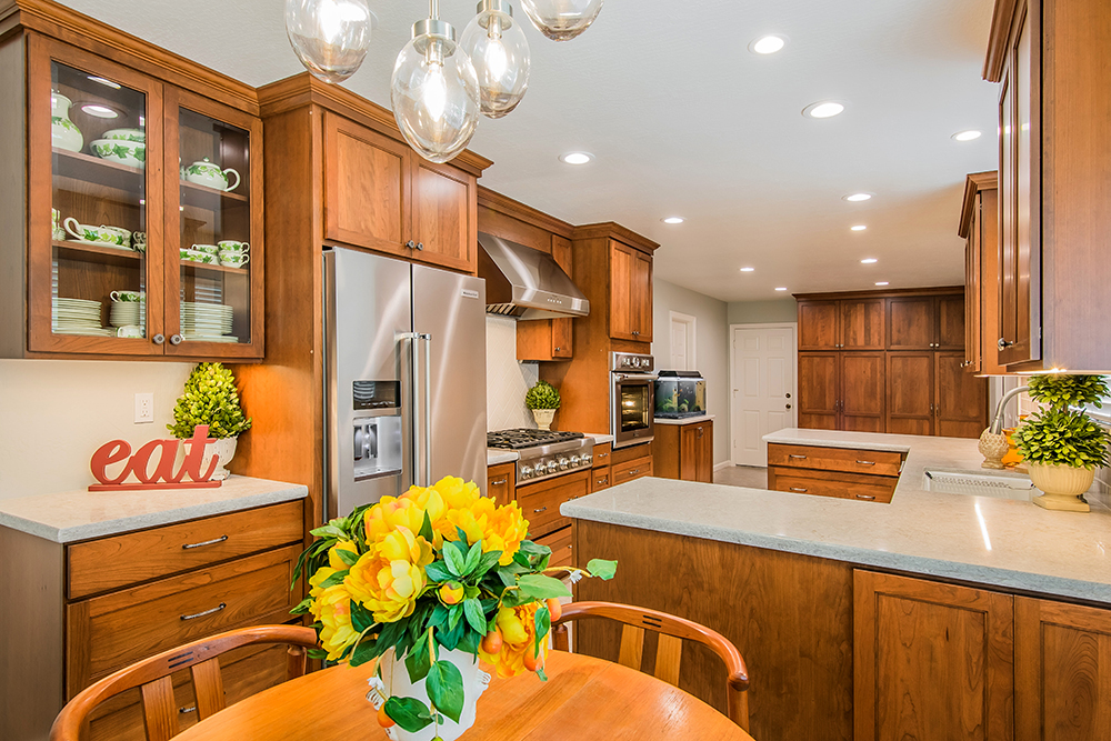 Picture of This updated kitchen is now bright and open. The lighting was completely renewed by removing the old florescent box and adding LED cans and undercabinet lighting. The Thermador gas cooktop oven and ra - Cook's Kitchen & Bath, Inc.