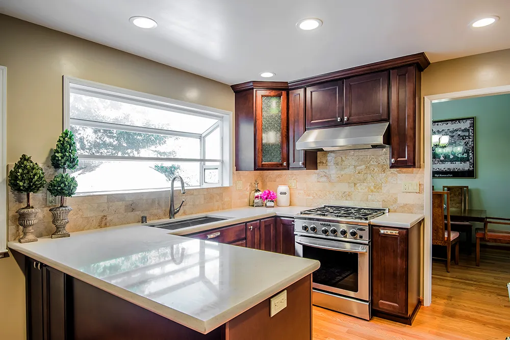 Picture of The owner of this Martinez kitchen wanted everything to be made new. With almost no changes to the layout Cook's Kitchen & Bath simply refreshed and updated everything. The cabinets are maple from Huntwood. The countertops are quartz from Silestone and the backsplash is a Tuscon granite with a special pencil accent. All the appliances are new and the stainless steel undermount sink and brushed faucet are from Dawn. - Cook's Kitchen & Bath, Inc.