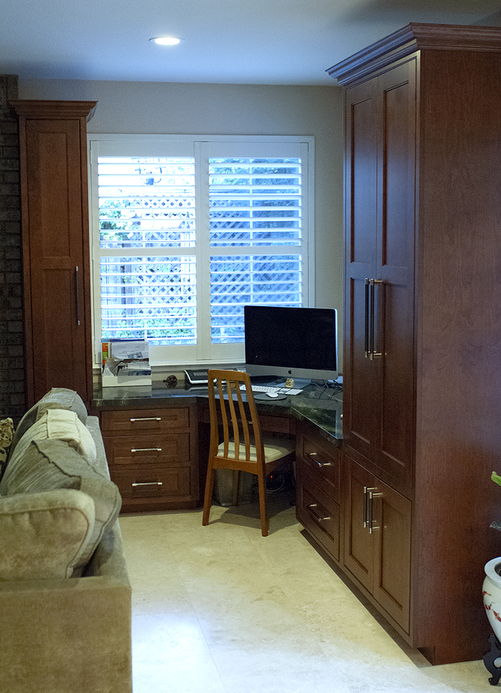 Picture of Cook's Kitchen & Bath placed a new office space at one end of this family room. It features plenty of storage thanks to tall Huntwood cabinets with inset doors and room to work on the matching granite - Cook's Kitchen & Bath, Inc.