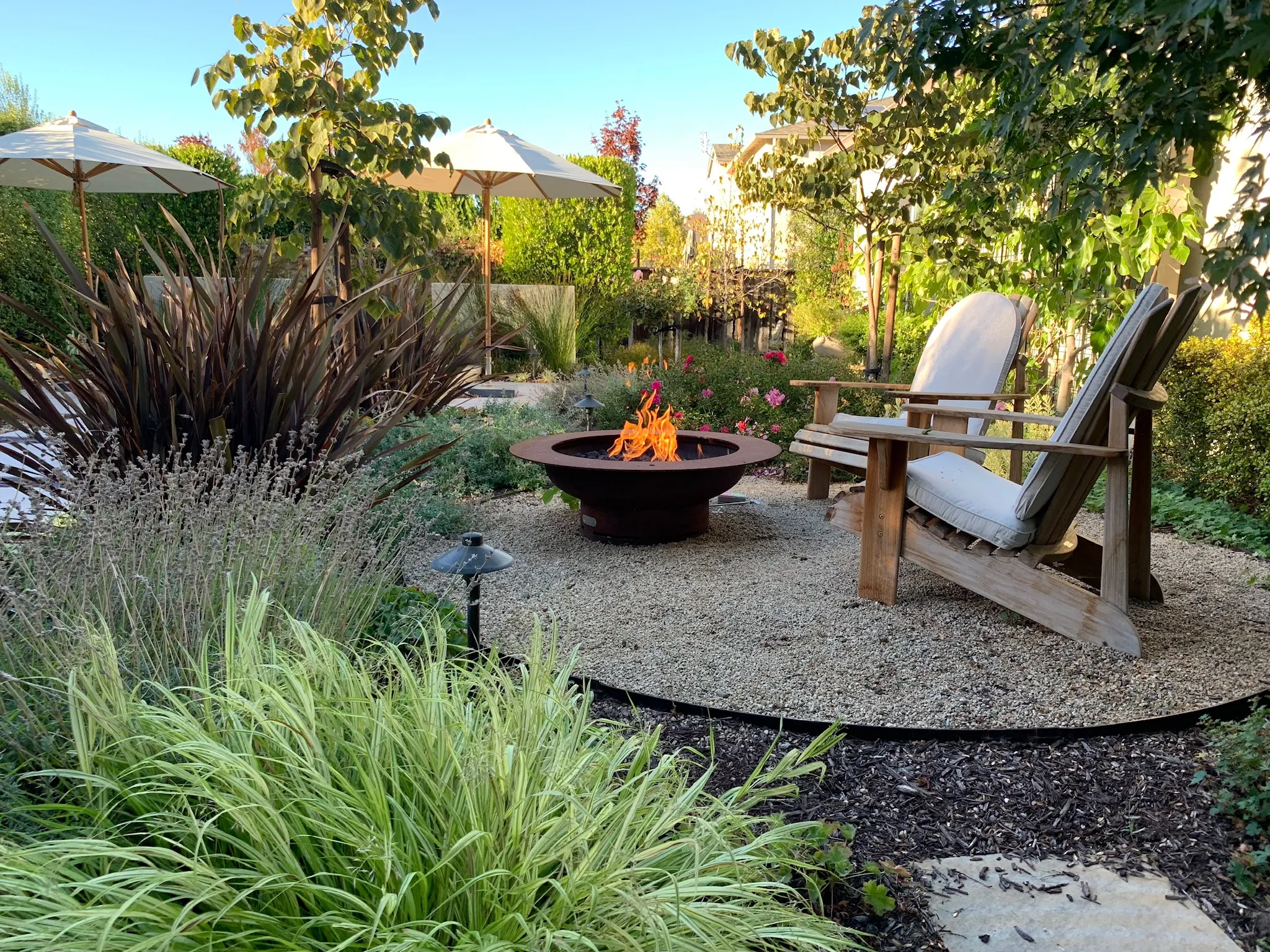 Picture of Koch & Associates installed this Corten steel fire pit in the midst of a soothing garden. - Koch & Associates, Inc.