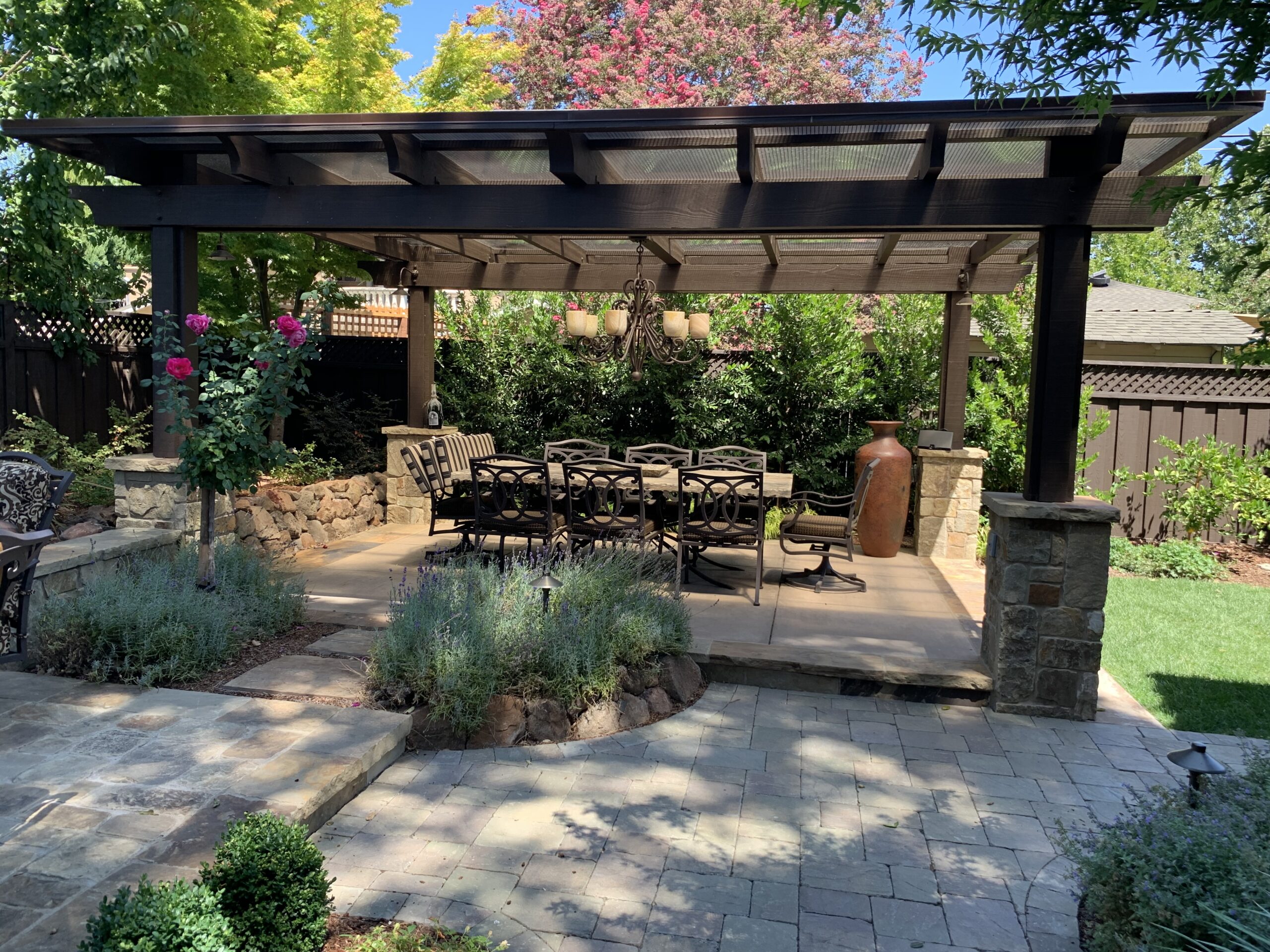 Picture of Koch & Associates installed an arbor with stone details to create a large dining area for this Tuscany-inspired home. - Koch & Associates, Inc.