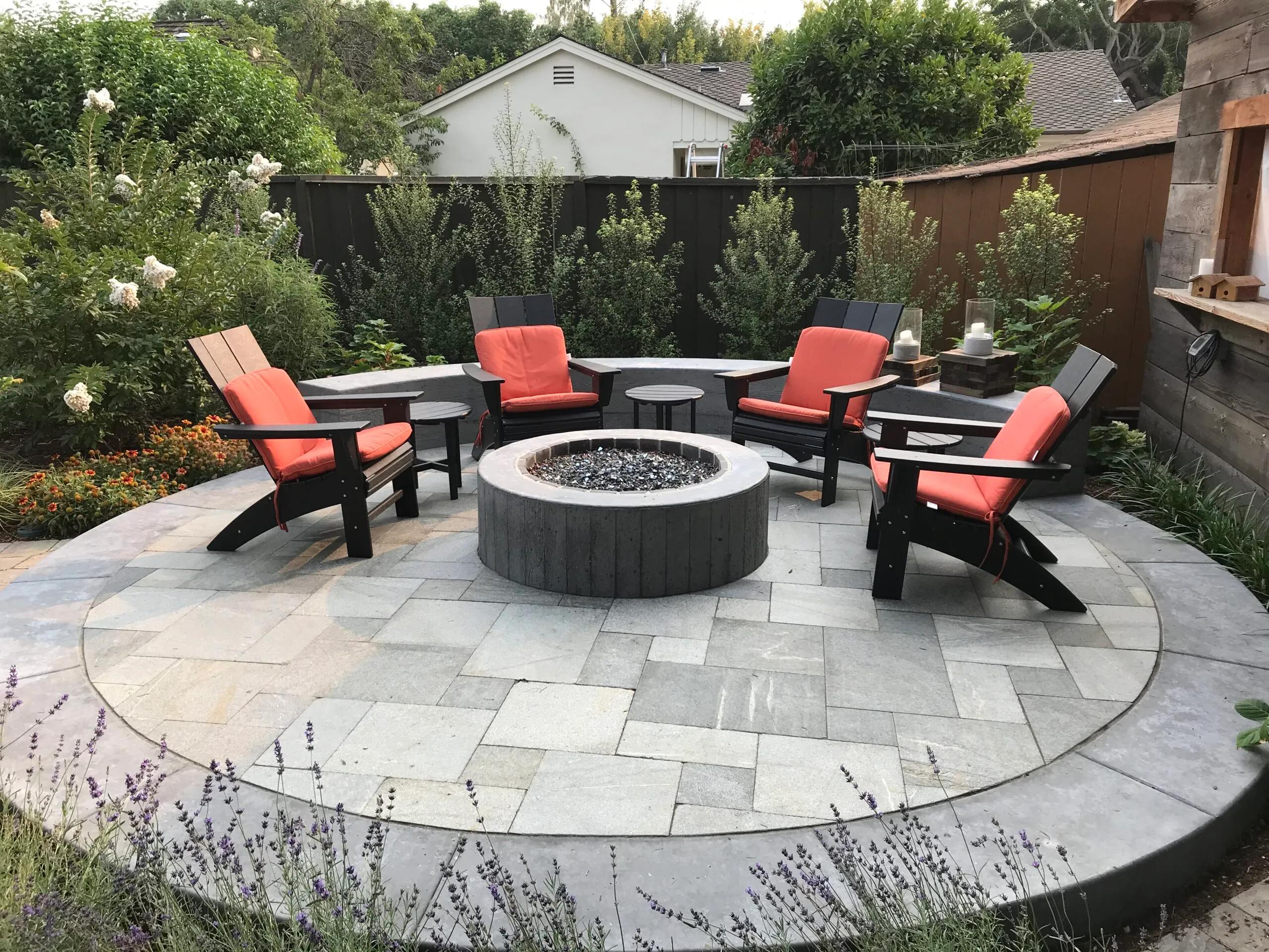 Picture of Koch & Associates installed a concrete fire pit a concrete seat wall and a stone patio in this backyard. - Koch & Associates, Inc.