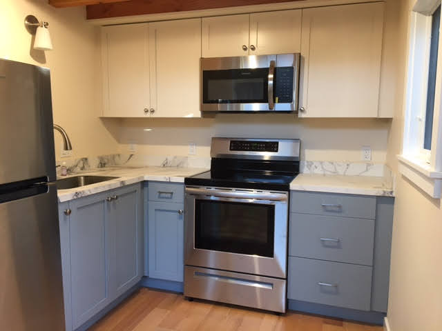 Picture of This kitchen renovation project features new tile countertops and backsplash walls. - Green Living Builders LLC